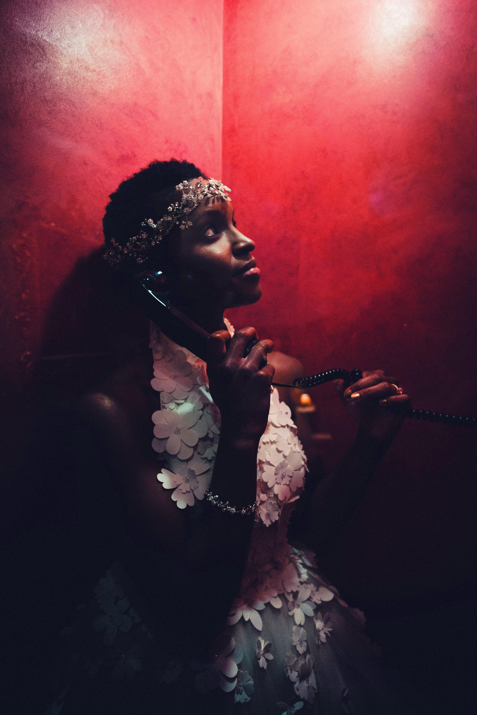 black bride, red wall, phone booth