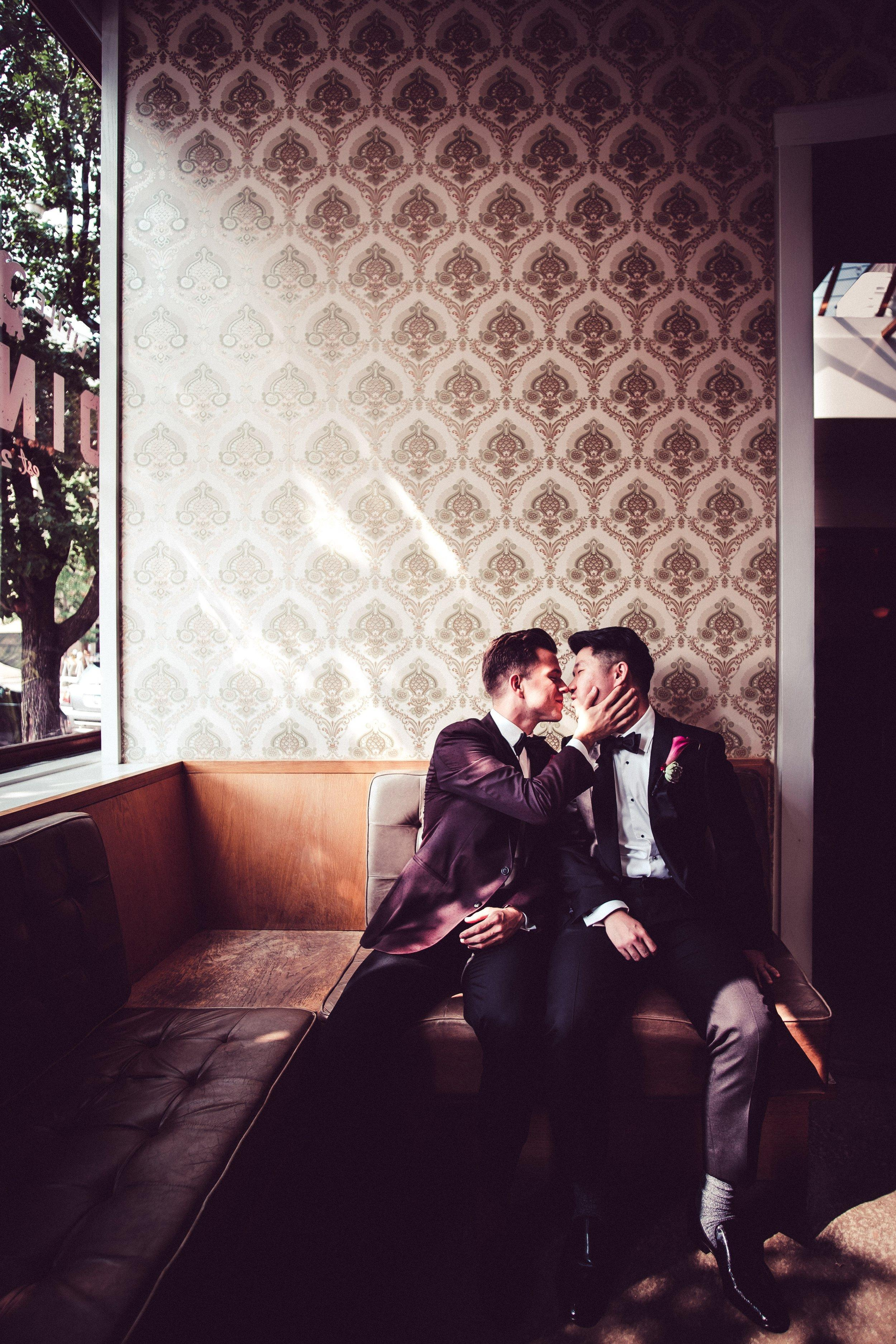 Same sex gay couple kissing in Chicago restaurant