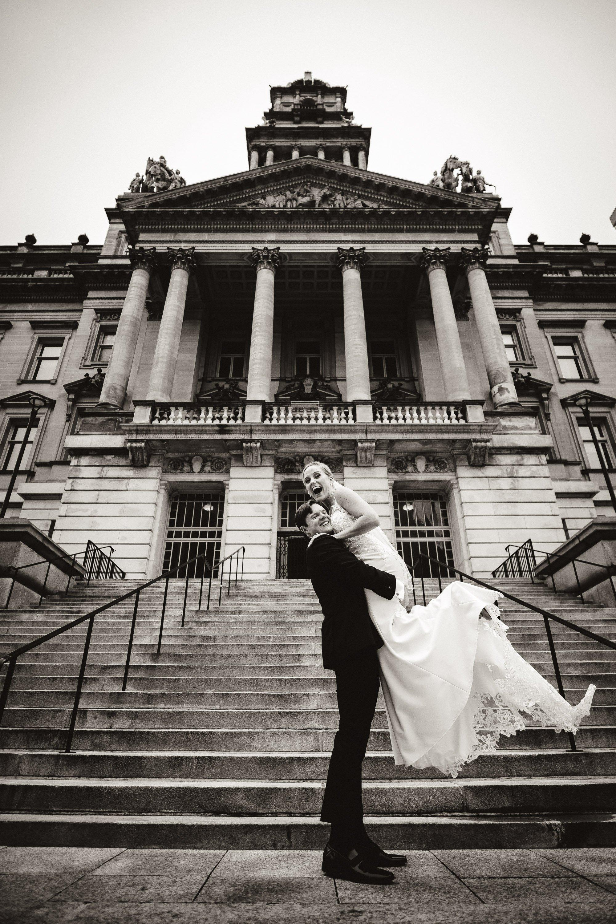 laughing couple on concrete steps old building detroit